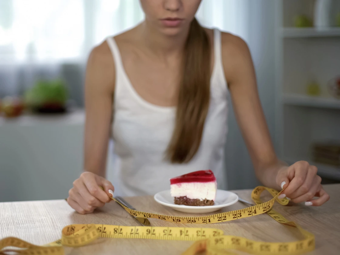 A woman can't eat a slice of cake
