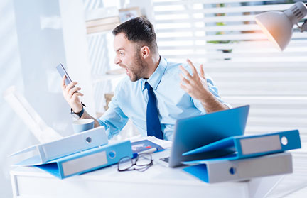 a man shouting at his mobile phone because of Irritability. This is a symptom of anxiety